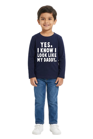 Boy wearing a navy full-sleeve slogan T-shirt on a white background.