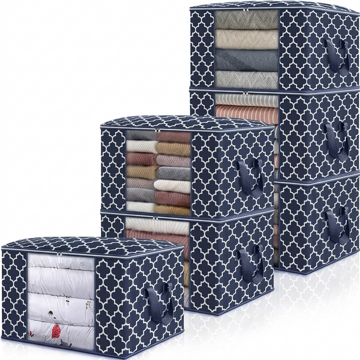 Stack of navy quilted-pattern storage bags with clear PVC fronts showing folded clothes inside